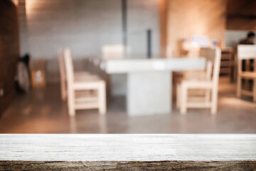 Empty wooden table space platform and blurred resturant or coffee shop background for product display montage.