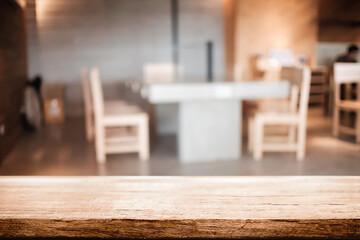 Empty wooden table space platform and blurred resturant or coffee shop background for product display montage.