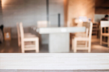 Empty wooden table space platform and blurred resturant or coffee shop background for product display montage.