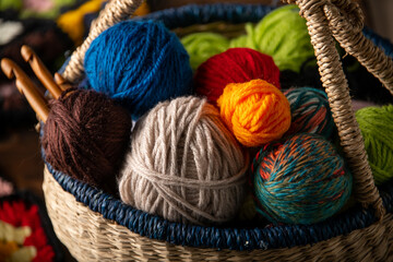 Fototapeta na wymiar Yarn balls and crochet needles in basket.