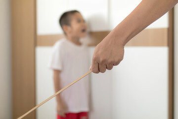 Asian young father hit his son with a wand with concept