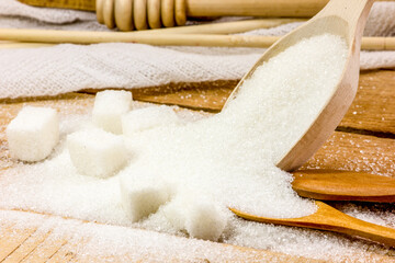 Wooden spoons and sugar. Diet. A lot of sugar.