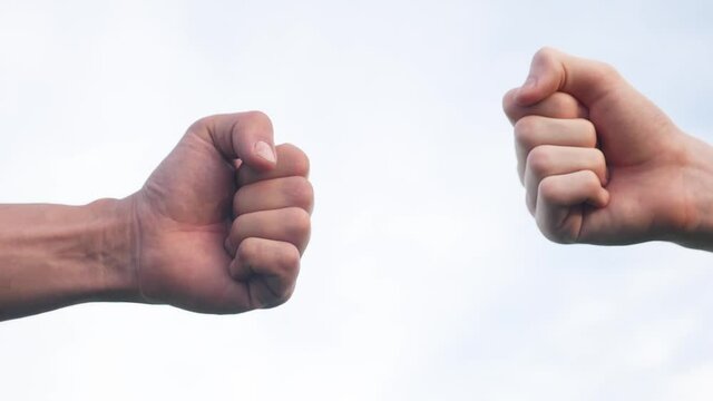 teamwork concept. fist to fist commit solidarity a respect and brotherhood gesture. business team lifestyle hands fists close-up. people of different skin colors partnership friendship teamwork