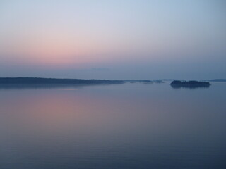 White nights on the Baltic Sea. Finnish skerries in fog and night haze. A beautiful landscape in...