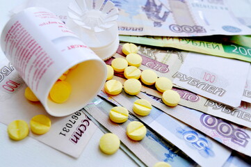 Composition consisting of money and pills. Money. Tablets. Medication.