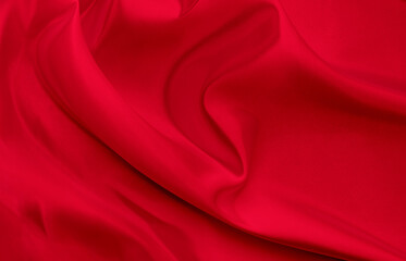 Black red satin dark fabric texture luxurious shiny that is abstract silk cloth background with patterns soft waves blur beautiful.