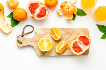 Cutting board with citrus fruits top view