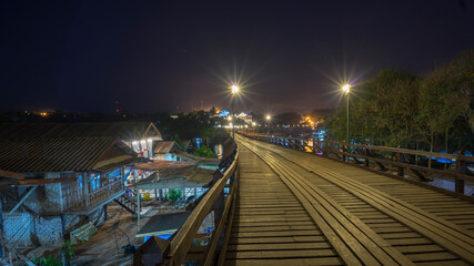 Fototapeta na wymiar Wooded bridge over the river in Sangkhlaburi District, Kanchanaburi, Thailand