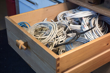 Drawer full of cables. White coax but also internet and phone wire and more.