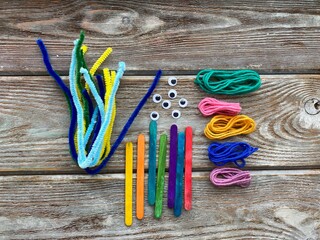 Set for children's creativity, pipe cleaners, plastic eyes and yarn, ready for needlework.