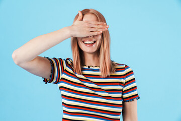 Image of young joyful woman laughing and covering her eyes