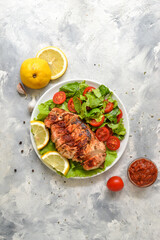 Grilled chicken breast salad with spinach and tomatoes. Healthy eating Fried chicken breast, lemon,...