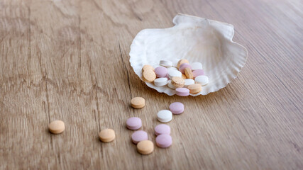 Tablets of calcium and shell on a wooden table. Medical concept. Minerals for health. Top view.