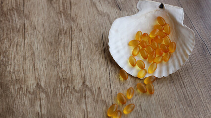 fish oil capsules on a wooden background