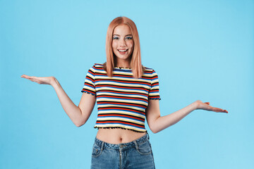 Image of charming joyful woman smiling and holding copyspace