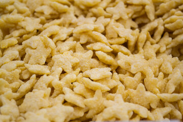 Sweet corn flakes for Breakfast in the shape of stars. Close up
