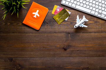 Flight booking - passport, cards, computer keyboard - on wooden background top view copy space