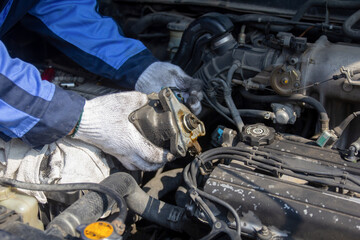 Check engine ignition system and change ignition coil. Car care service..Replacing ignition coil and spark plugs..Car mechanic fixing ignition coil on gasoline engine.
