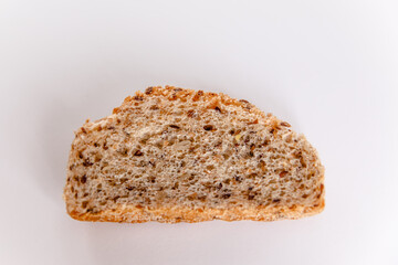 The piece of the French baguette isolated on a white background.