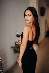 Fototapeta na wymiar Relax time and alcohol theme. Beautiful happy lady drinking glass of red wine.
