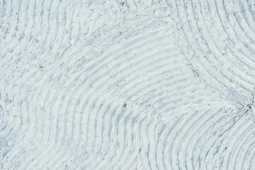 Fototapeta na wymiar Texture of white wavy concret. Abstract geometric pattern