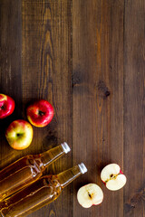 Apple cider vinegar bottle on wooden background top view copy space