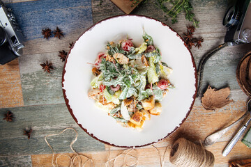 Appetizing caesar salad on the wooden table