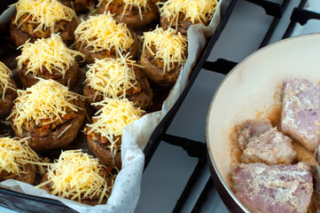 mushrooms with grated cheese before baking in the oven