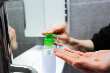 close up. man puts liquid soap on his hands .