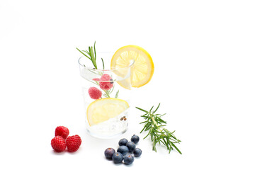 Tonic drink with lemon and fruits. White background, studio shot