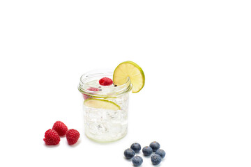 Tonic drink with lime. White background, studio shot