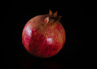 Garnet with water droplets close up on a black background