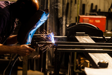 man welds metal