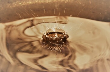 Close up of golden water droplet splashing
