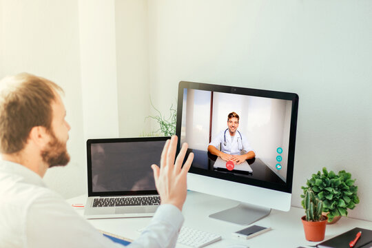 Young Man Waving To His Doctor Through A Video Call On The Computer