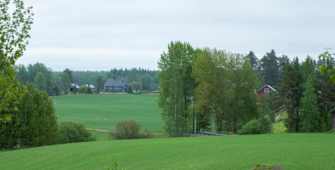 Summer landscape, countryside of Finland. Renion Kymenlaakso. Fields and rural houses