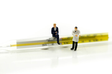 Miniature people : Doctor checking body temperature with Thermometer ,protective preventing contagious diseases spread of coronavirus COVID-19