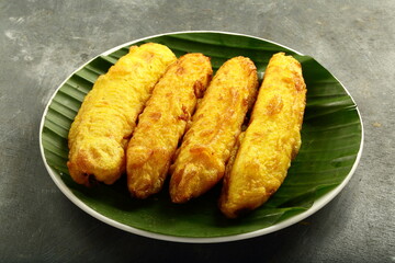 Homemade snack foods background- fried ripe bananas with sweet coconut filling
