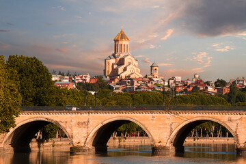 Saarbrucken Bridge known also as Dry Bridge with Sameba Cathedral in the background,  in Tbilisi, Georgia