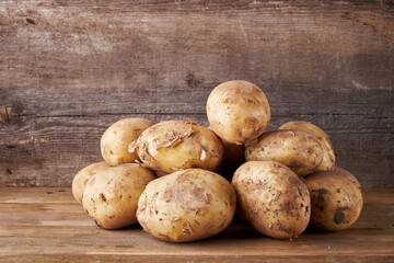 fresh potatoes on a wooden background