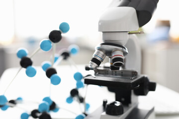 Close-up of modern device for laboratory investigation. Black and white equipment on working table. Tool to examine sample material. Light room. Lab and science concept