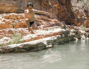Paradise Valley Agadir Morocco. The boy jumps into the lake.