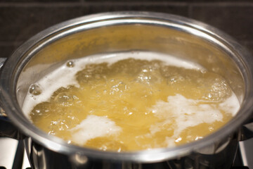 Boiling water inside a kitchen iron pot