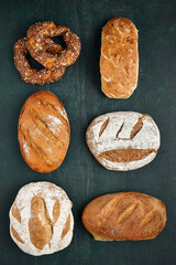 Traditional freshly baked, crusty artisan homemade sourdough breads. Top view, Healthy, clean, natural diet, back to nature concept. Copy space.