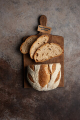 Traditional freshly baked, crusty artisan homemade sourdough bread and slices. Top view, Healthy, clean, natural diet, back to nature concept. Copy space.