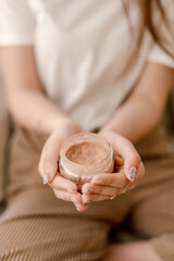 close up of a woman hands holding a bottle of hand cream