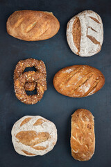 Traditional freshly baked, crusty artisan homemade sourdough bread and slices. Top view, Healthy, clean, natural diet, back to nature concept. Copy space.