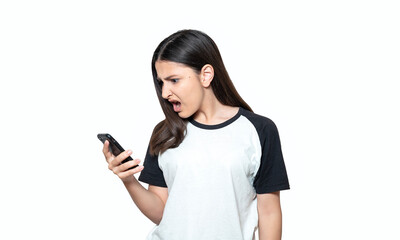 Annoyed angry young girl mad about spam message stuck phone looking at smartphone isolated on white...