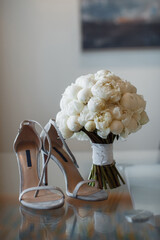 beautiful fresh wedding bouquet with bride's shoes