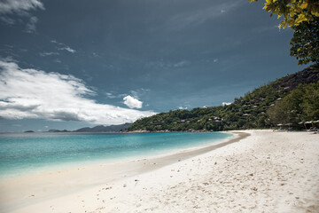 Beautiful seychelles island, ocean shore with white sand and blue sky